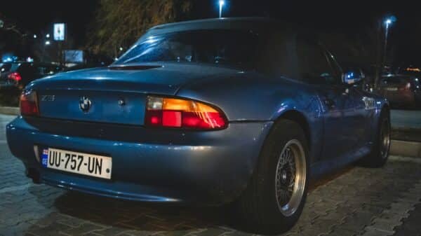 a blue sports car parked on the side of the road