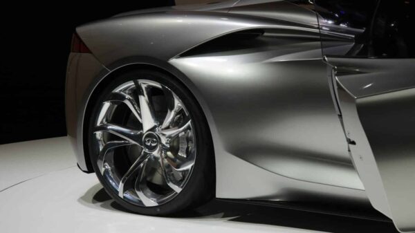 a silver sports car on display at a show
