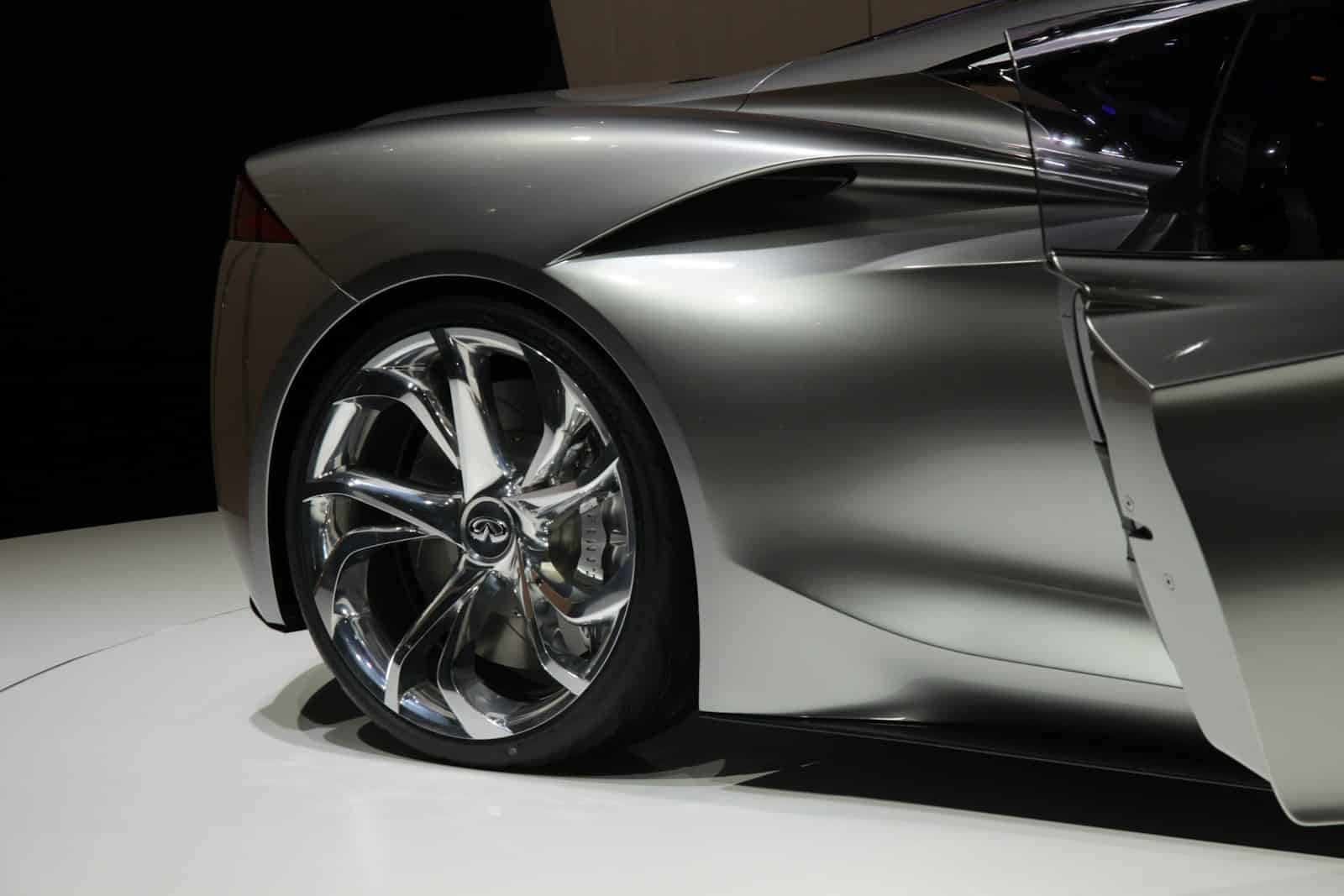 a silver sports car on display at a show