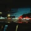 a car driving down a street at night