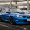 A blue subaru wrx sti parked in a lot.