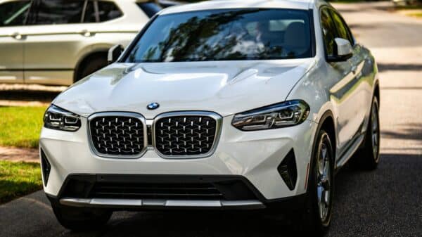 A white BMW suv parked on the side of the road