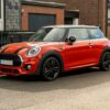 A red mini cooper parked on the side of the road