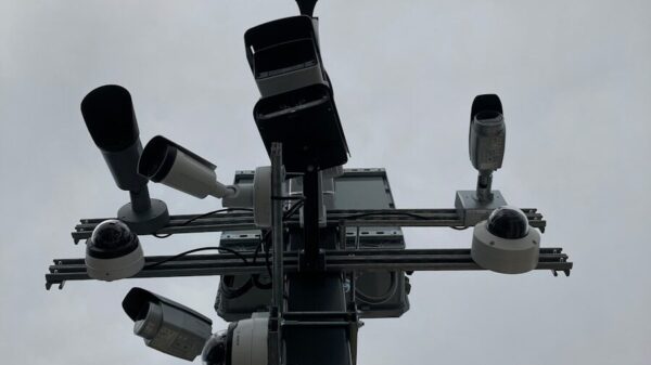 a traffic light with multiple cameras attached to it