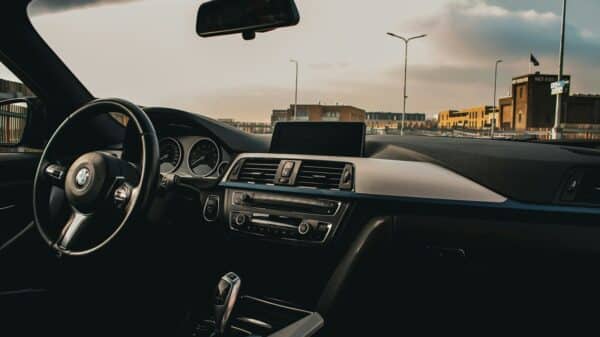 a car dashboard with a steering wheel and dashboard lights