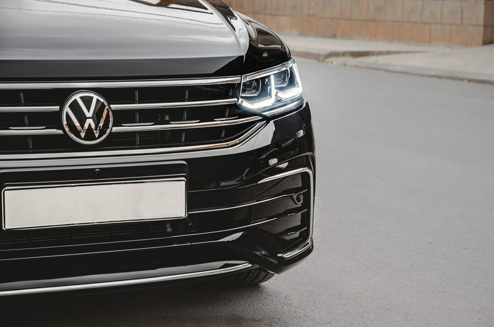 a close up of the front of a black volkswagen suv