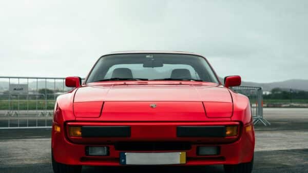 A red sports car parked in a parking lot