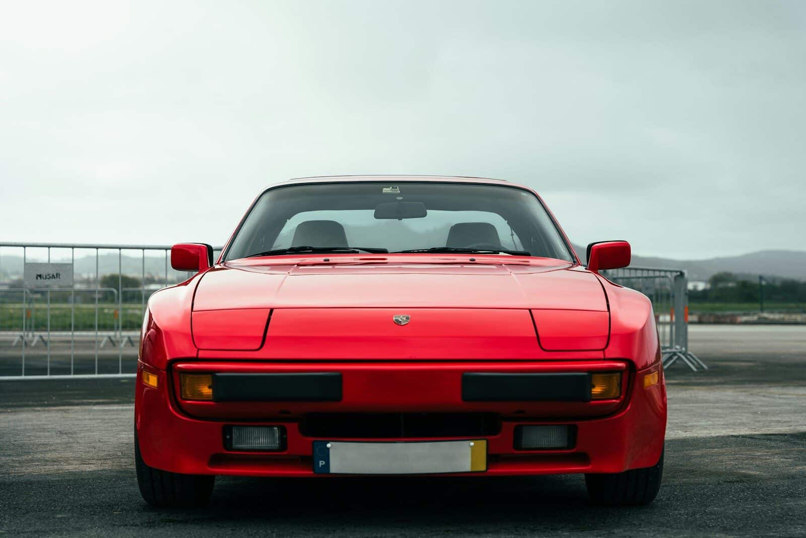 A red sports car parked in a parking lot