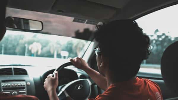 man driving car