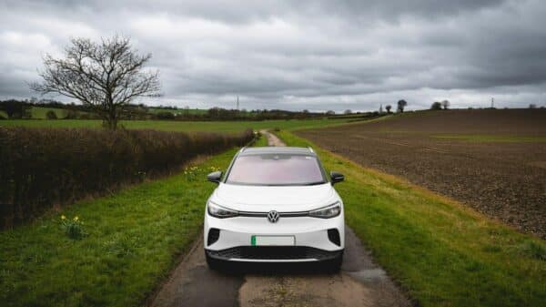 White electric car parked on a rural road