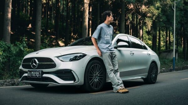 A man standing on the hood of a car