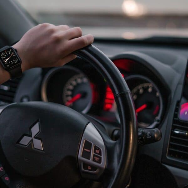 person driving black honda car