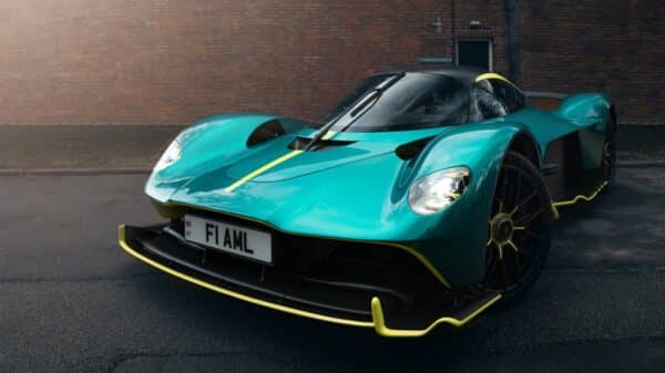 A blue sports car parked in front of a brick building