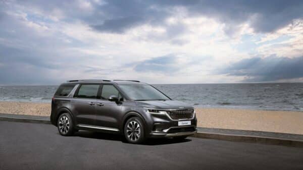 a grey suv parked on the side of a road near the ocean