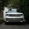 White range rover parked on a paved driveway.