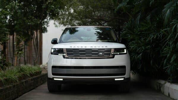 White range rover parked on a paved driveway.