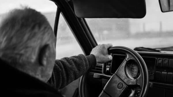 Man driving a car on a blurry day
