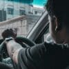 man in black shirt driving car during daytime