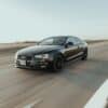 black audi sedan on road during daytime