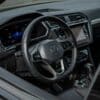 Modern car interior with digital dashboard and steering wheel.