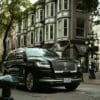 a black car parked on the side of the road