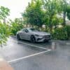 A silver car parked on a wet road