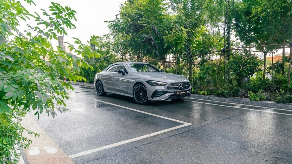A silver car parked on a wet road