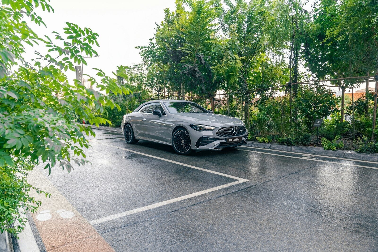 A silver car parked on a wet road