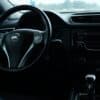 the interior of a car with a steering wheel and dashboard