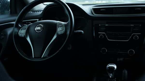 the interior of a car with a steering wheel and dashboard