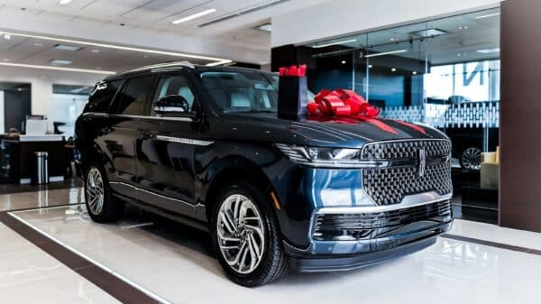 Dark blue luxury suv with red bow on hood
