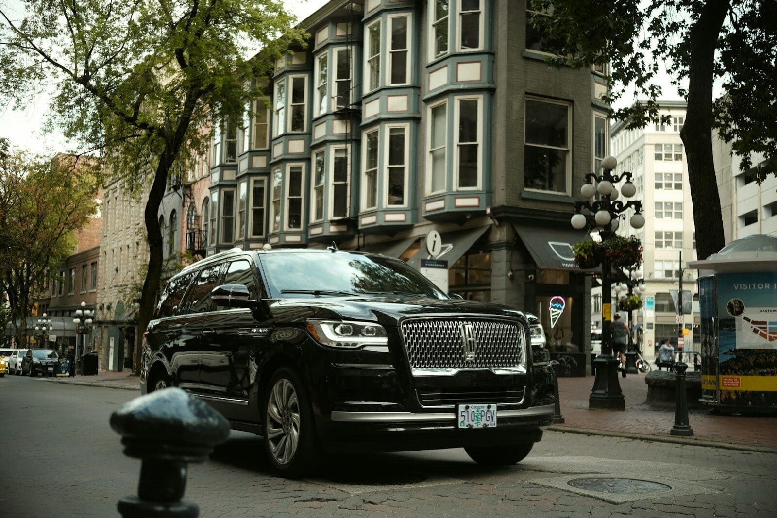 a black car parked on the side of the road