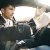 Man driving a car, gesturing with hand