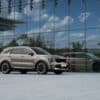a silver car parked in front of a building